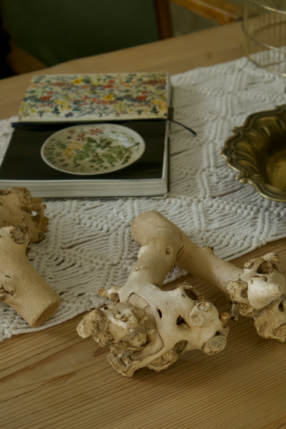 Driftwood, macrame, and decorative objects arranged on a wooden table.