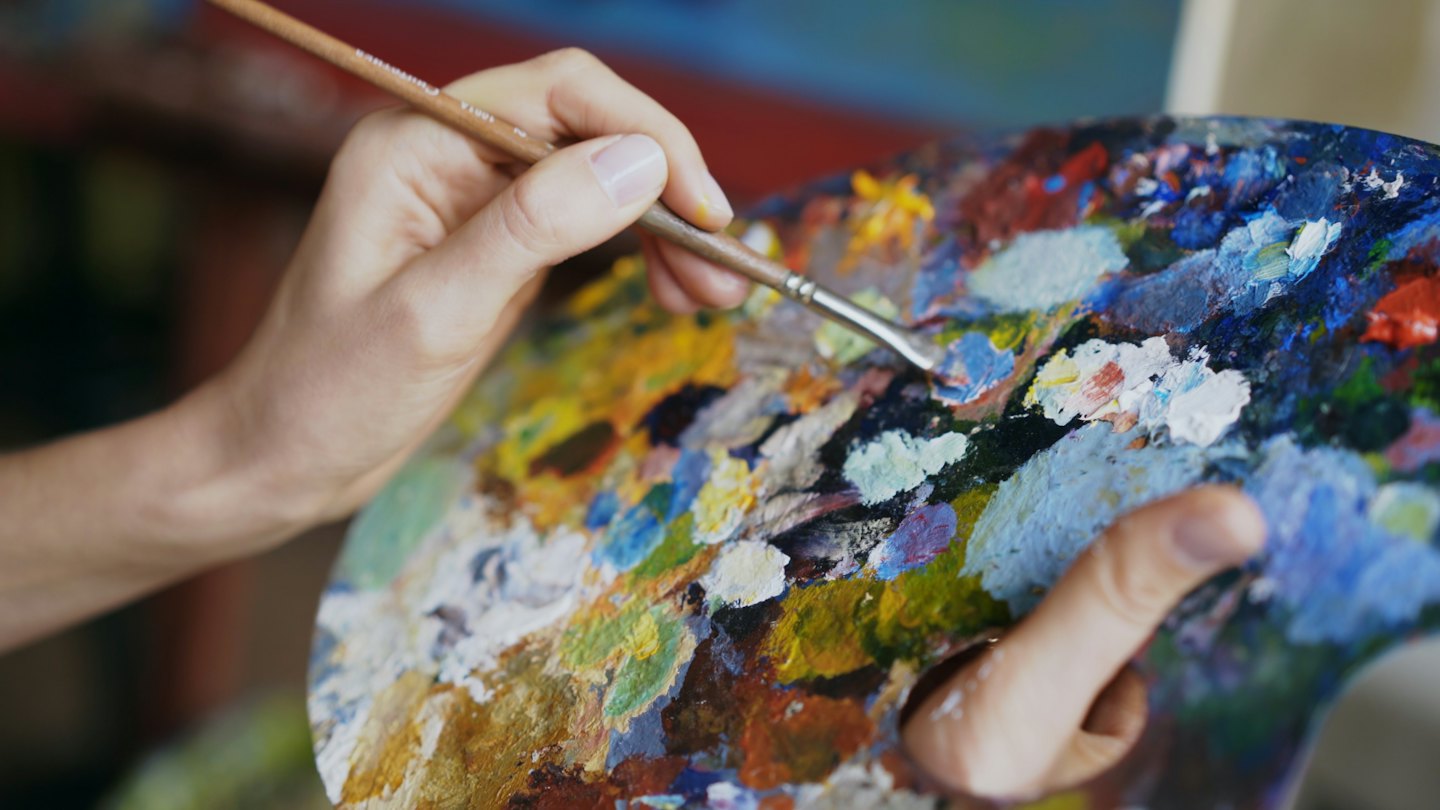 Creator holds handcrafted materials in the studio.